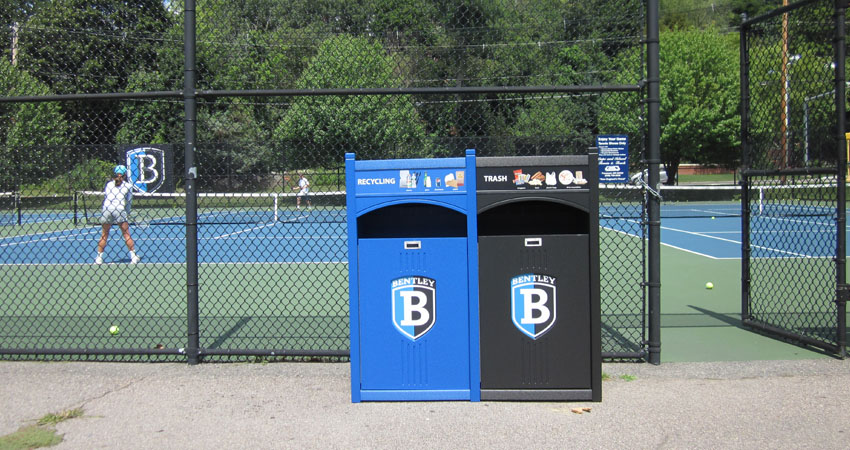 Bentley University campus recycling program bin placement at outdoor tennis court
